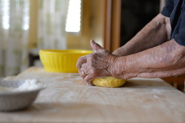 grandmother make homemade fresh pasta for italian restaurant