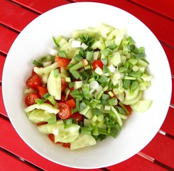 Fresh salad on the red table