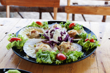 Baked Scallops with Cheese in black dish