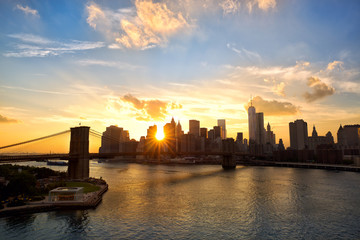 Manhattan skyline and Brooklyn Bridge at sunset, New York