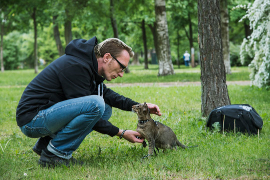 Man Playing The Cat Outdoor