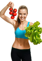 Young smiling woman with fresh tomatoes and lettuce, organic food