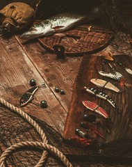 Fishing tools and fresh pike on a wooden table