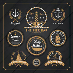 Vintage nautical labels set on dark wood background
