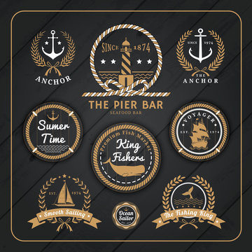 Vintage nautical labels set on dark wood background