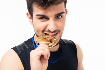 Sports man biting medal