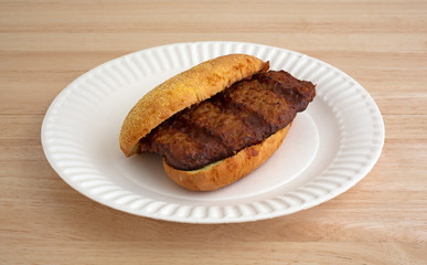 Pork rib sandwich on a paper plate