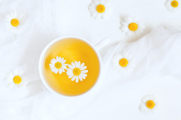 Healthy natural chamomile herbal yellow tea in white cup with