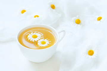 Cup of yellow chamomile tea organic aromatic beverage with fresh