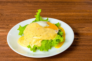 poached eggs, ham, lettuce leaf and delicious buttery fresh holl