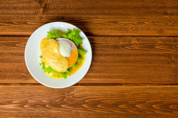 top down poached eggs, ham, lettuce leaf and delicious buttery f