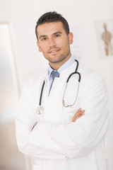 portrait of handsome young doctor in office
