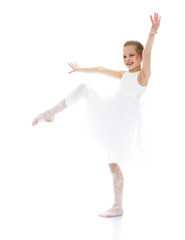 Fototapeta premium Ballerina child raised her leg up and pulling sock