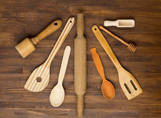 Wooden kitchen tools on vintage wooden background. 