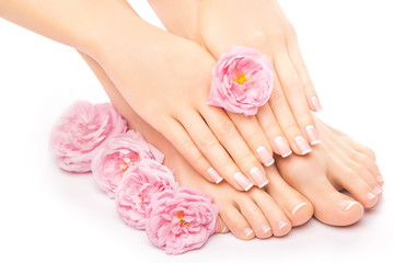 Obraz na płótnie Canvas Relaxing pedicure and manicure with a pink rose flower