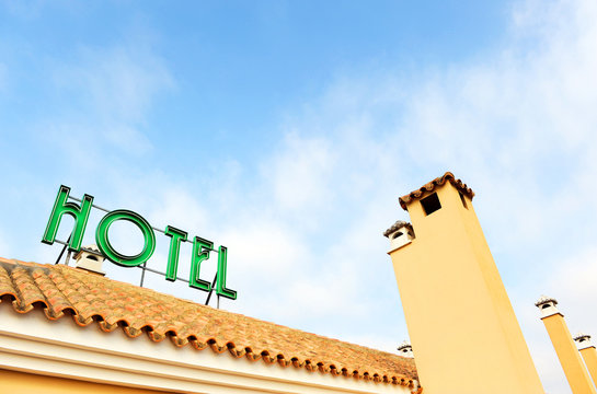Hotel sign placed on the roof, bright neon