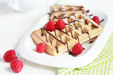 Belgium whole wheat waffles with raspberries and chocolate decor