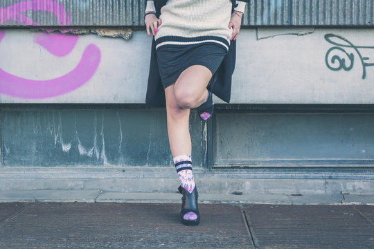 Detail of a girl posing in an urban context