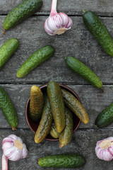 Closeup of some pickled and fresh cucumbers.