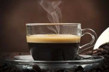 Cup of coffee on the table with seeds