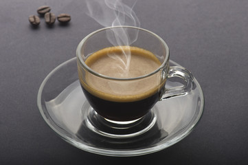 Cup of coffee on the black background
