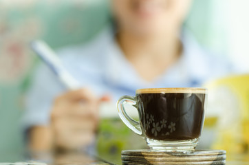 Hot coffee with woman working in the coffee shop