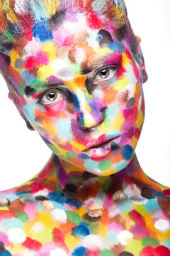 Girl with colored face painted. Art beauty image.