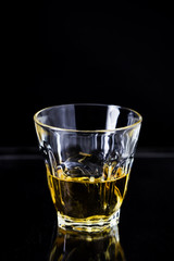 Glasses of whiskey on wood background.