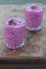 Closeup of a glass of cold beetroot soup.