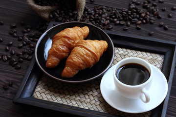 Black coffee and croissant.