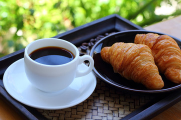 Black coffee and croissant.
