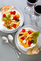 Healthy summer light pasta salad with fresh raw tomatoes, anchov