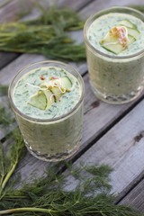 Closeup of glasses of cold cucumber and dill soup.