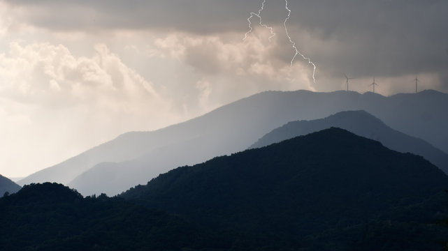 Electric storm over the wind farm, turbines. Lunigiana, Italy.