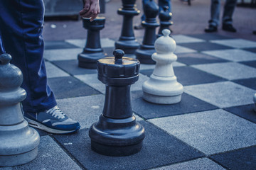 Big board with chess on the street.