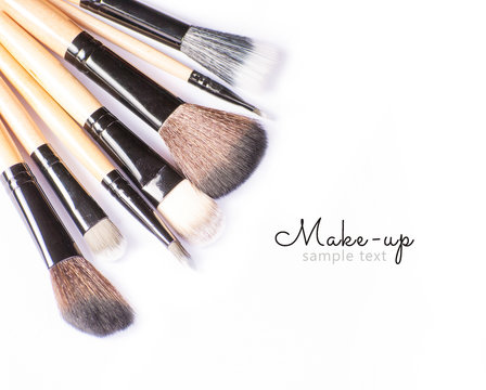 Makeup brushes on white background with sample text