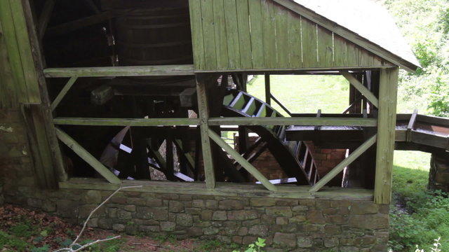 Waterwheel with mill race supplying water, turning with sound.