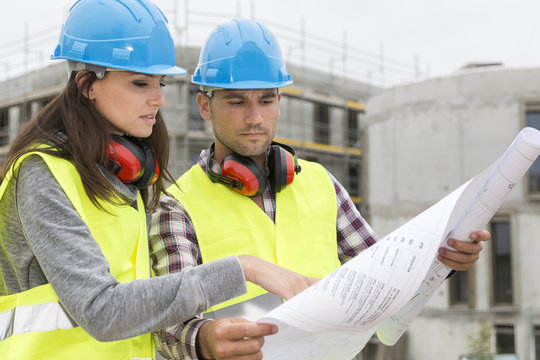 Engineers on building site cheking plans