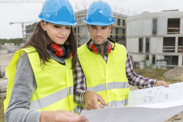 Engineers on building site cheking plans