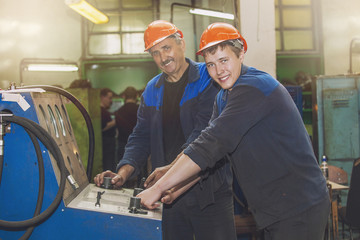 Men work on the old factory for the installation of equipment