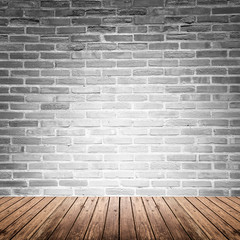 Old interior room with brick wall and wood floor