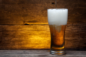 glass of beer over vintage wood 