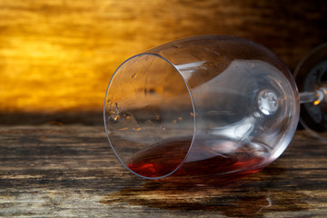 Overturned glass of wine on floor 