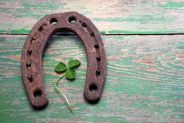 Old iron rusty metal horseshoe on weathered wood 