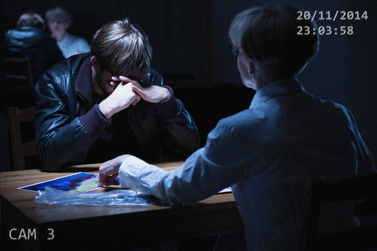 Broken man in interrogation room