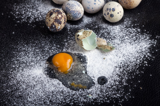 One quail egg broken into flour