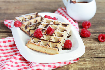 Belgium whole wheat waffles with raspberries and chocolate decor