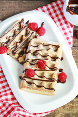 Belgium whole wheat waffles with raspberries and chocolate decor