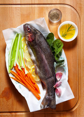 raw fresh fish with vegetables and spices. carrots and celery. o