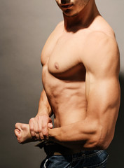 Fototapeta na wymiar Muscular man flexing his bicep